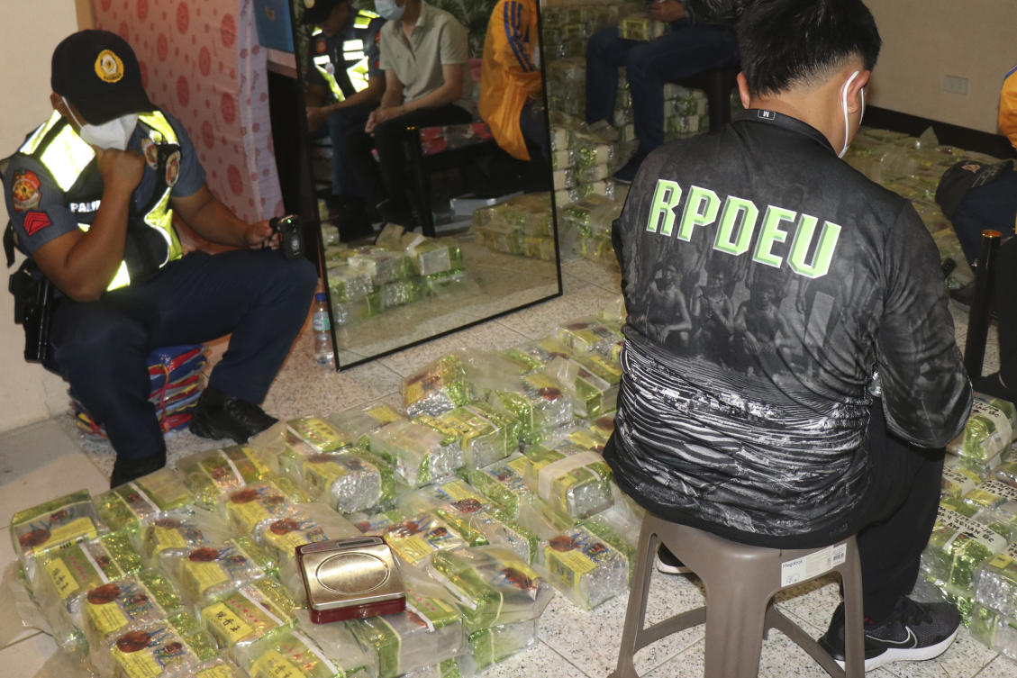 Police officers inspect tea bags containing suspected methamphetamine during a raid at a house in Baguio City, Philippines on Wednesday March 29, 2023. (Police Regional Office Cordillera RPIO via AP)