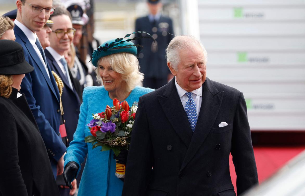 Britain’s King Charles III (R) and Britain’s Camilla (2ndR), Queen Consort, are greeted by a delegation after landing at Berlin Brandenburg Airport in Schoenefeld near Berlin, on Mar. 29, 2023. (AFP)