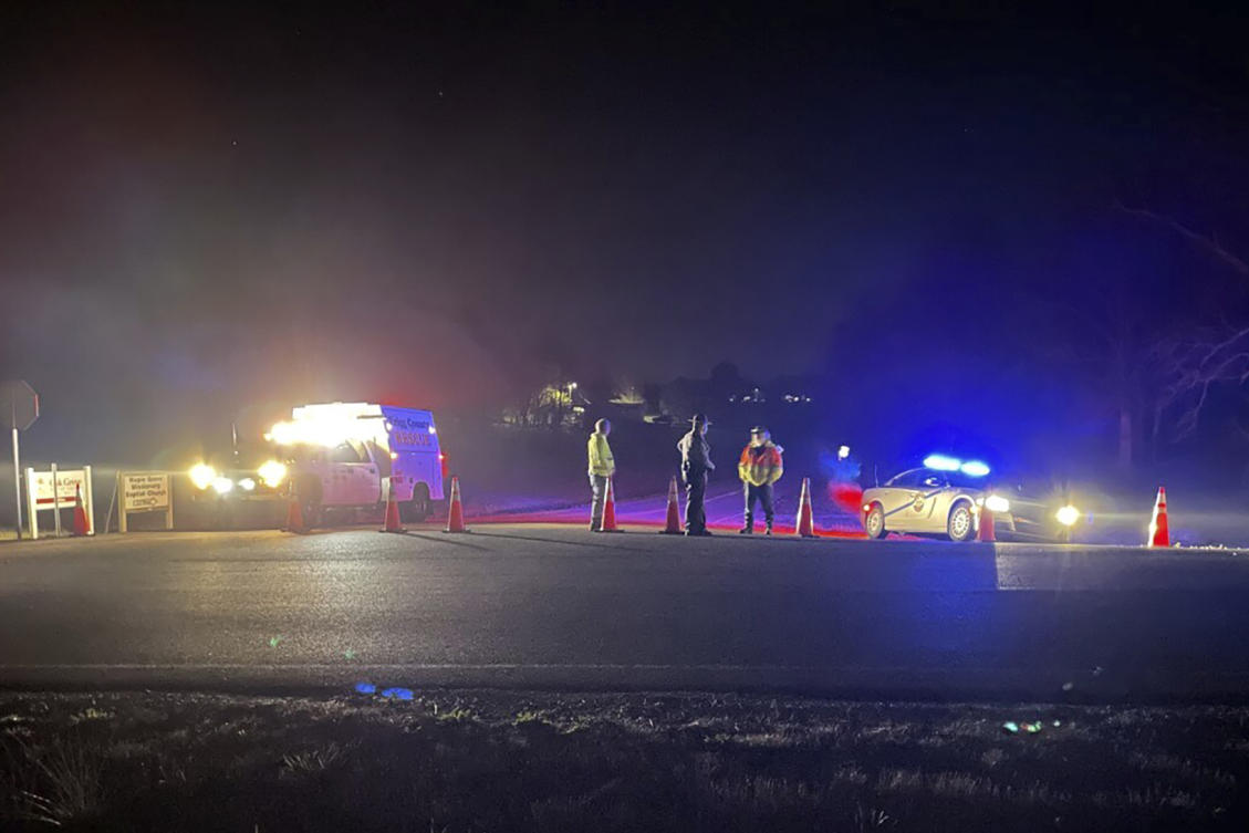 Emergency responders are seen near a site where two military helicopters crashed during a routine training mission in Trigg County in southwestern Kentucky on March 30, 2023. (WSMV-TV via AP)