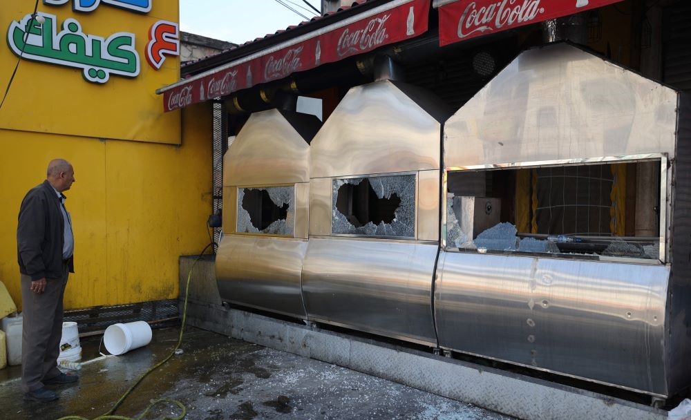 A man inspects the damage to a restaurant following an attack by Israeli settlers on the Palestinian town of Hawara in the occupied West Bank on March 28, 2023. (AFP)