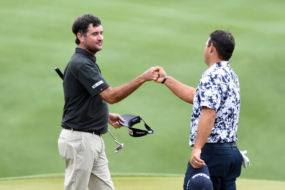 Bubba Watson fist bumps Patrick Reed of the United States after their match during the first round of the World Golf Championships-Dell Technologies Match Play at Austin Country Club on March 24, 2021. (AFP)