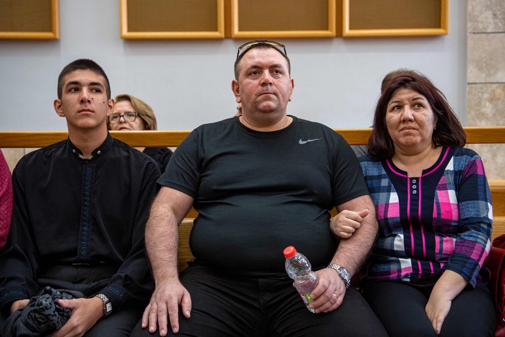 Roman Zdorov (C) and his wife Olga sit at the District Court in Nazareth, on March 30, 2023. (Gil Eliyahu-JINIPIX/AFP))