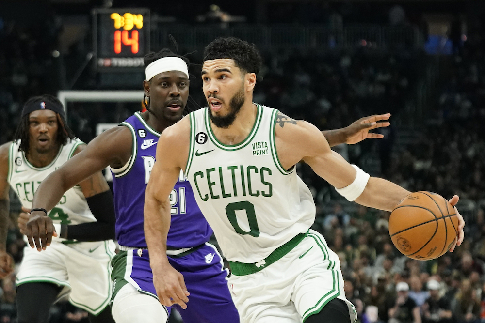 Boston Celtics’ Jayson Tatum drives to the basket against Milwaukee Bucks’ Jrue Holiday during the first half of an NBA game Thursday in Milwaukee. (AP)