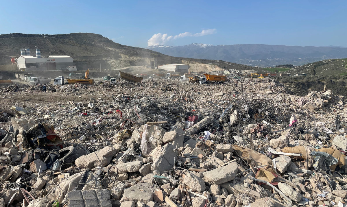 A dump site of earthquake rubble is seen next to a brick and cement block factory on the outskirts of Antakya. (Reuters)