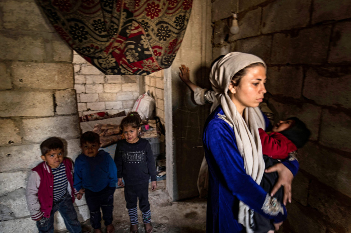 Displaced Syrians living in war-damaged buildings, are pictured in Syria's rebel-held northern city of Raqa. (AFP)