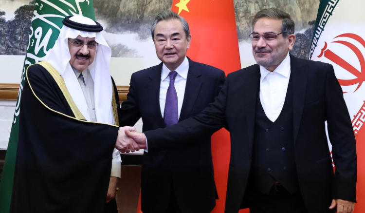 China’s Wang Yi, Iran’s Ali Shamkhani and Saudi Arabia’s Musaad bin Mohammed Al Aiban pose for photo during a meeting. (REUTERS)