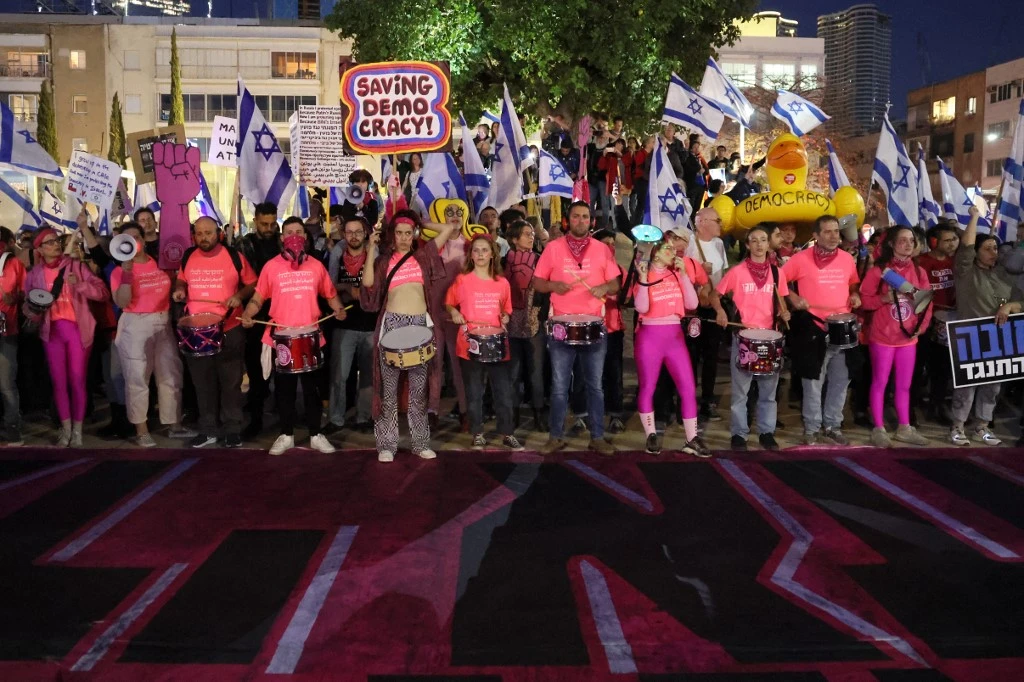 Scores of protestors are taking to the streets to protest Netanyahu's latest government's attempts at a judicial coup (File/AFP)
