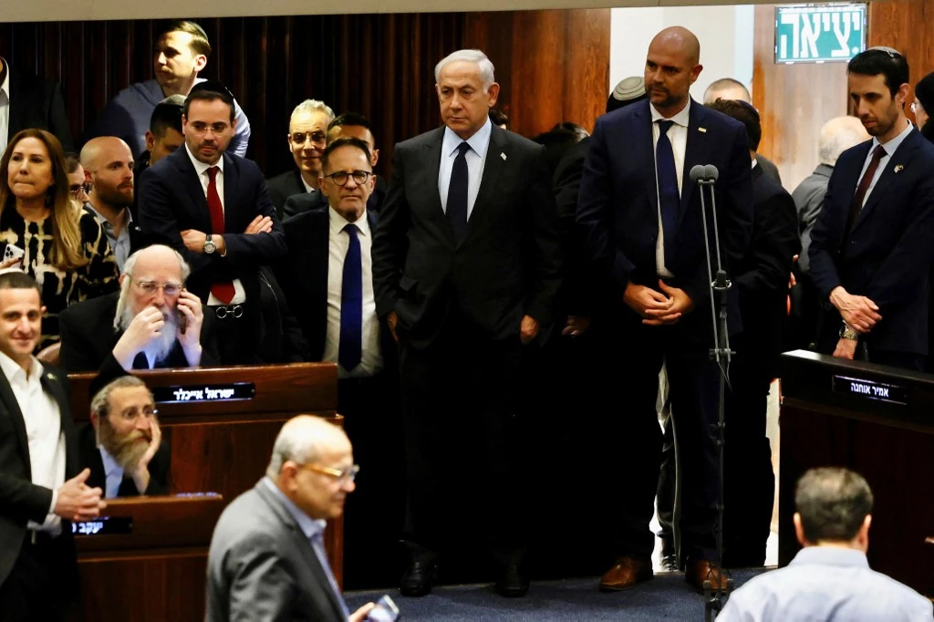 Amid protests and increasing international pressure, Israeli PM Netanyahu agreed to pause his proposed judicial overhaul (AFP)