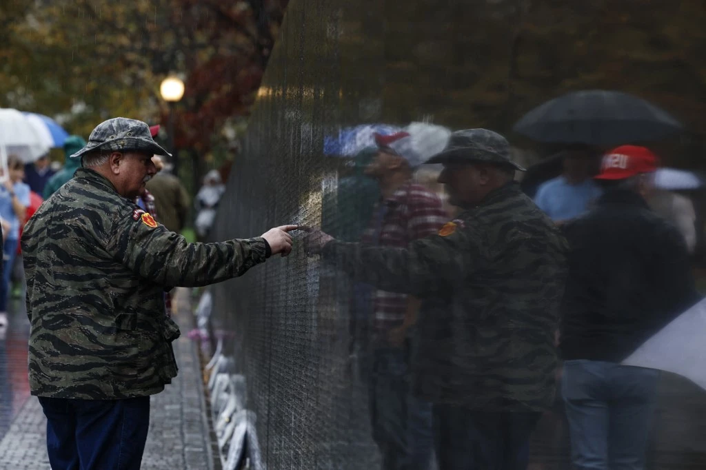 Veterans look for names of fallen soldiers etched on the Vietnam Veterans Memorial in Washington, DC (File/AFP)