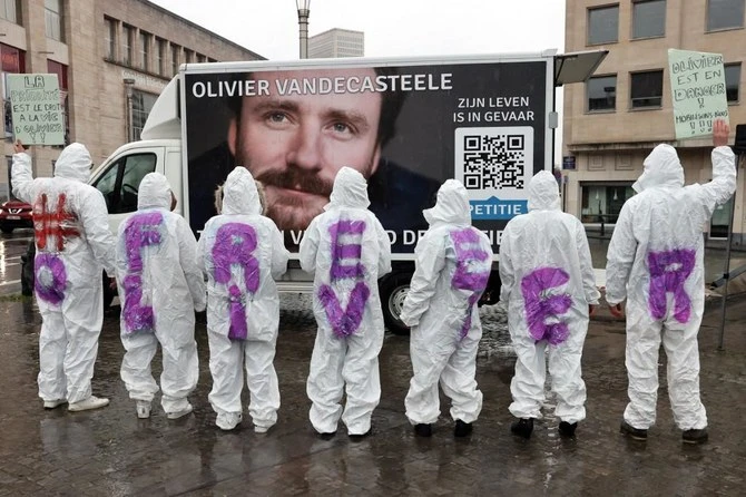 Protesters wear clothes reading “Free Olivier” and hold placards in Brussels. (File/AFP)