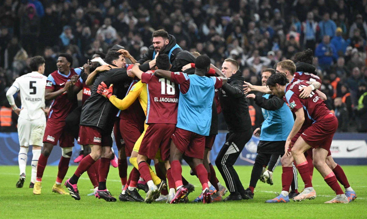 Annecy's players celebrate after winning their French Cup quarterfinal football match against Olympique de Marseille at the Velodrome stadium in Marseille, southern France, on Wednesday. (AFP)