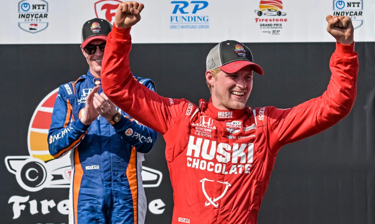 PNC Chip Ganassi Racing driver Scott Dixon, left, claps as Huski Chocolate Chip Ganassi Racing driver Marcus Ericsson celebrates on the Victory Lane podium after winning the Grand Prix of St. Petersburg auto race Sunday in St. Petersburg, Fla. (AP)