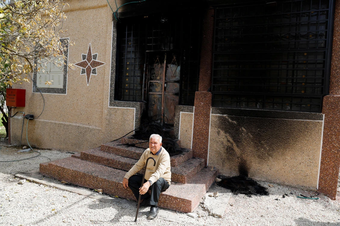 A Palestinian sits in front of a burned house after an Israeli settlers’ rampage in Hawara on Mar. 5, 2023. Hawara has been the scene of a violent rampage last week by dozens of settlers seeking revenge for the shooting of two Israeli brothers. (Reuters)