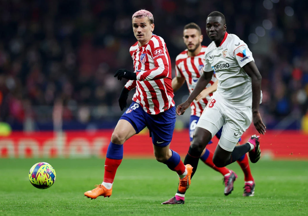 Sevilla’s Pape Gueye in action with Atletico Madrid’s Antoine Griezmann during their La Liga match at Metropolitano, Madrid on Mar. 4, 2023 (Reuters)