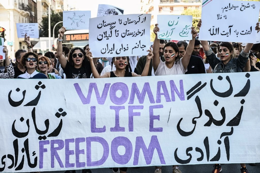 Iranians living in Greece chant slogans and hold placards during a demonstration, following the death in Tehran of Mahsa Amini. (File/AFP)