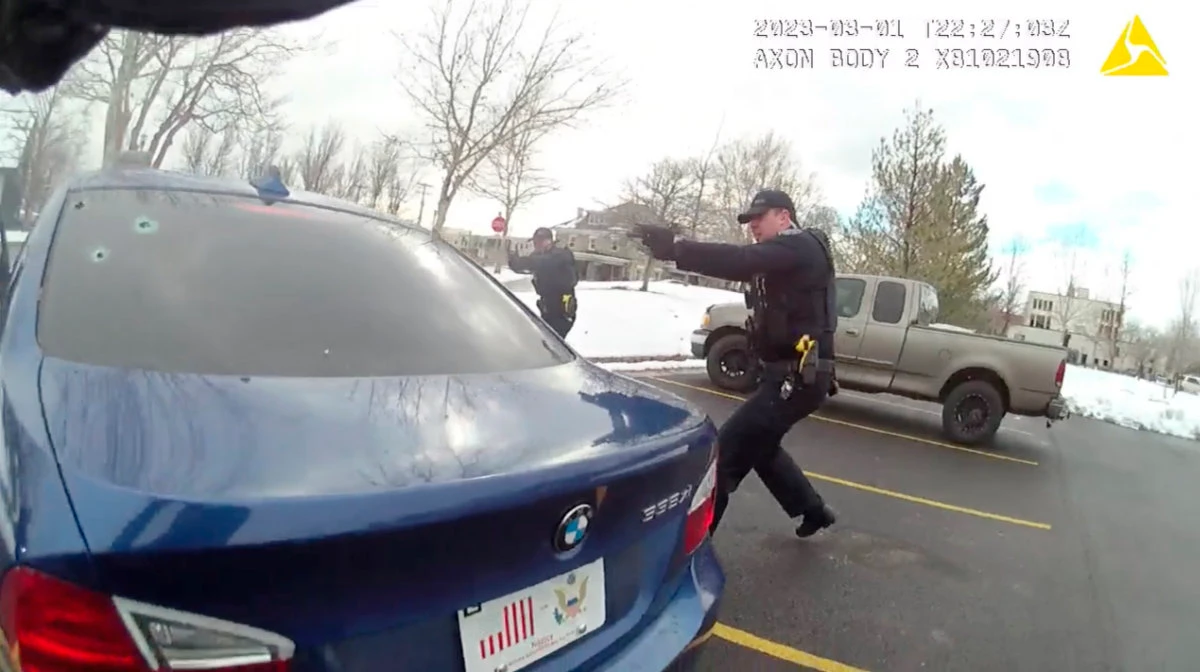 In this image taken from from police body camera video, police officers point their weapons at a car during a traffic stop on March 1, 2023, in Farmington, Utah. (Farmington City Police Department via AP)