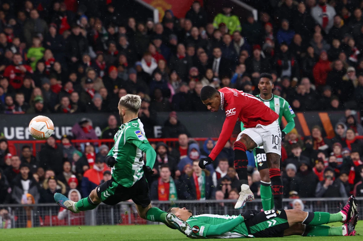 Manchester United's striker Marcus Rashford (center right) shoots to score their opening goal of the UEFA Europa league round of 16 first leg against Real Betis at Old Trafford stadium in Manchester, England, on March 9. 2023. (AFP)