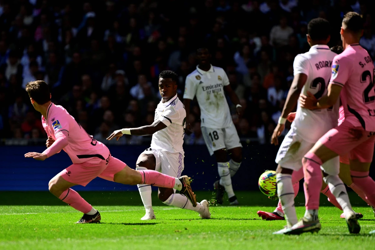 Real Madrid's Brazilian forward Vinicius Junior (C) shoots to score during the Spanish league between Real Madrid CF and RCD Espanyol at the Santiago Bernabeu stadium in Madrid on March 11, 20223. (AFP)