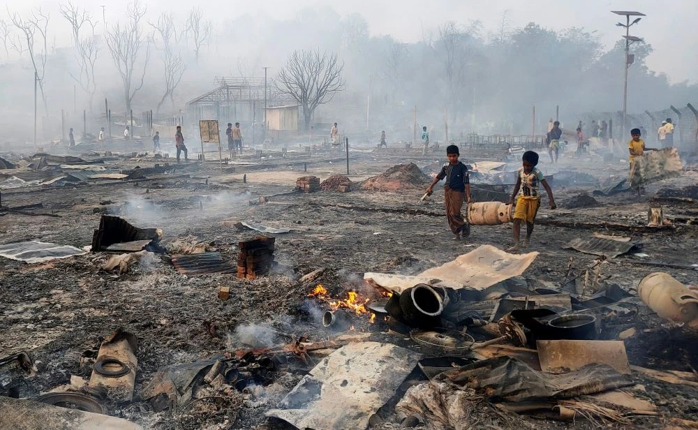 Rohingya refugee boys salvage a gas cylinder after a major fire in Balukhali camp at Ukhiya in Cox's Bazar district, Bangladesh, Sunday, March 5, 2023. (AP Photo)