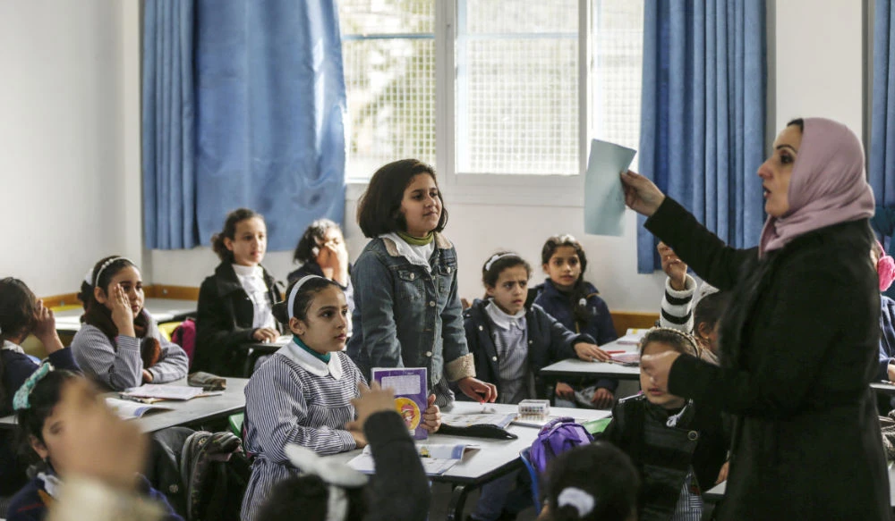 Palestinian schoolgirls attend a class at a school belonging to the United Nations Relief and Works Agency for Palestine Refugees (UNRWA) in Gaza City. (AFP)