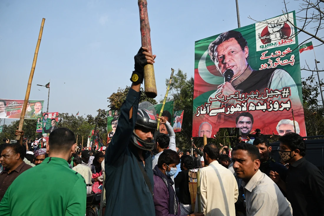 Supporters of former Pakistan's prime minister Imran Khan block a road near Khan's residence to prevent officers from arresting him in Lahore. (AFP)