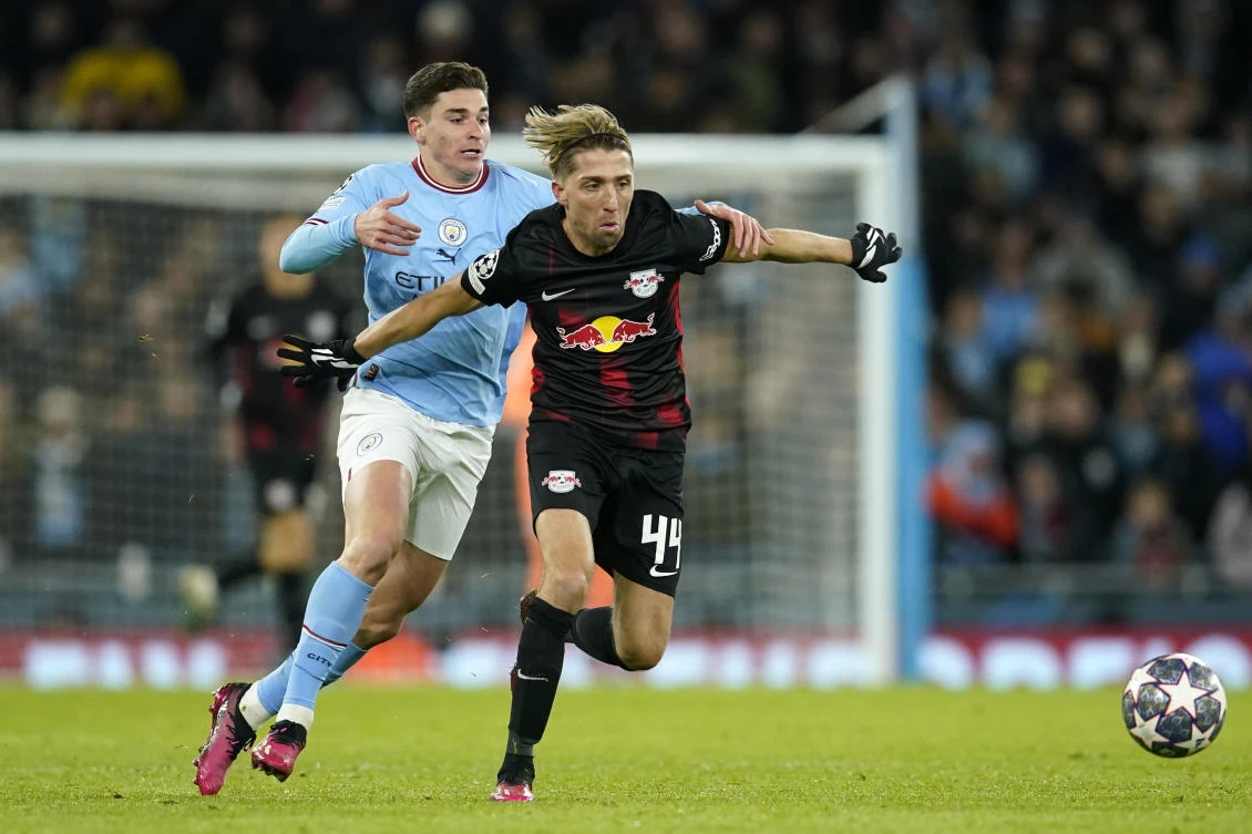 Manchester City’s Julian Alvarez and Leipzig’s Kevin Kampl challenge for the ball during their Champions League round of 16 second leg match at the Etihad stadium in Manchester on Mar. 14, 2023. (AP)