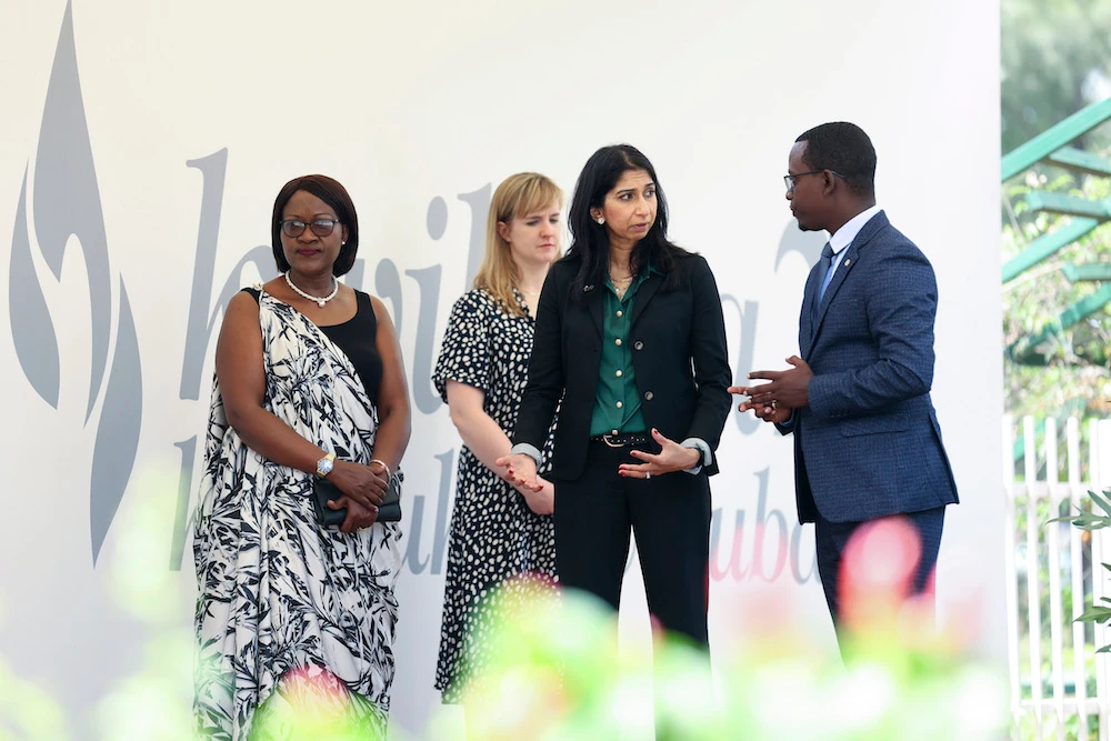 Britain's Home Secretary Suella Braverman, 2nd right, speaks to genocide survivor and memorial official Theoneste Karenzi, right, accompanied by Rwandan politician Monique Mukaruliza, left. (AP)