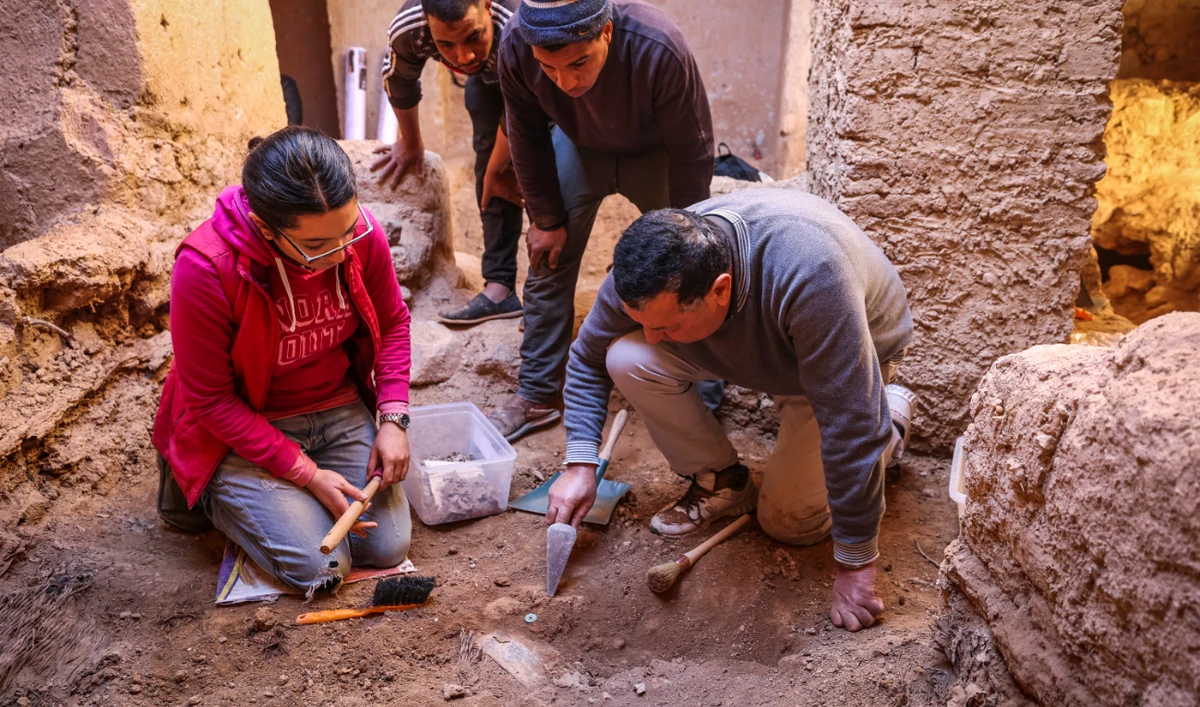 Archaeologists dig in the ruins of a synagogue in the Jewish neighbourhood, or mellah, in the village of Tagadirt in Morocco's oasis region of Tata on February 28, 2023. (AFP)