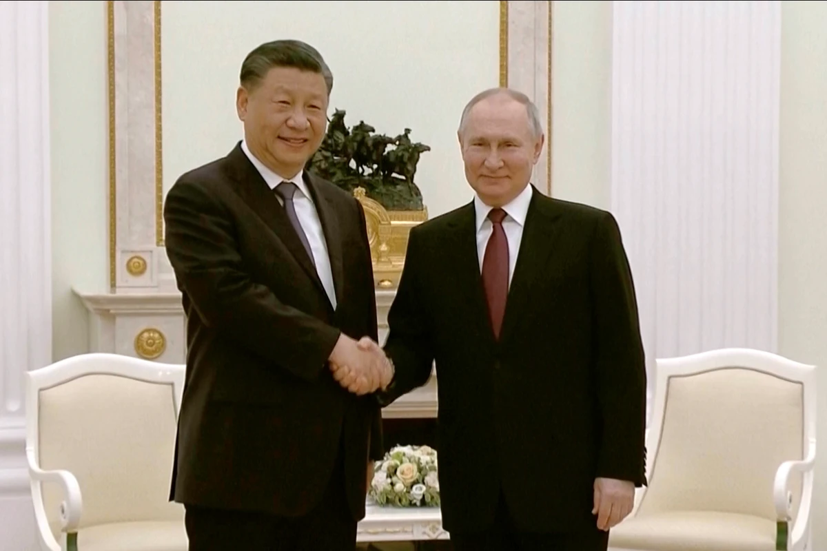 China's President Xi Jinping, left, and Russian President Vladimir Putin shake hands during their meeting in Moscow, March 20, 2023. (AP)