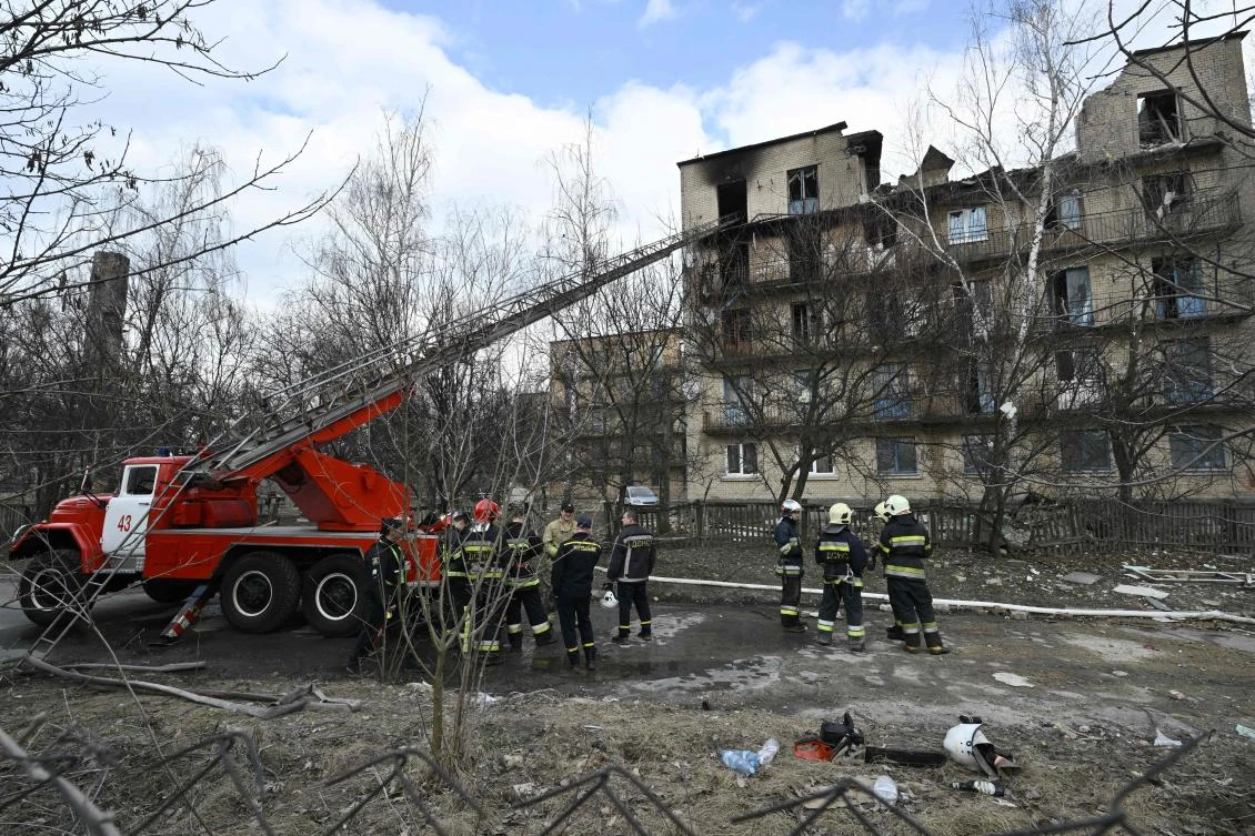 Rescuers work at a partially destroyed building after an air strike in the town of Rzhyshchiv, in the Kyiv region on Mar. 22, 2023. (AFP)