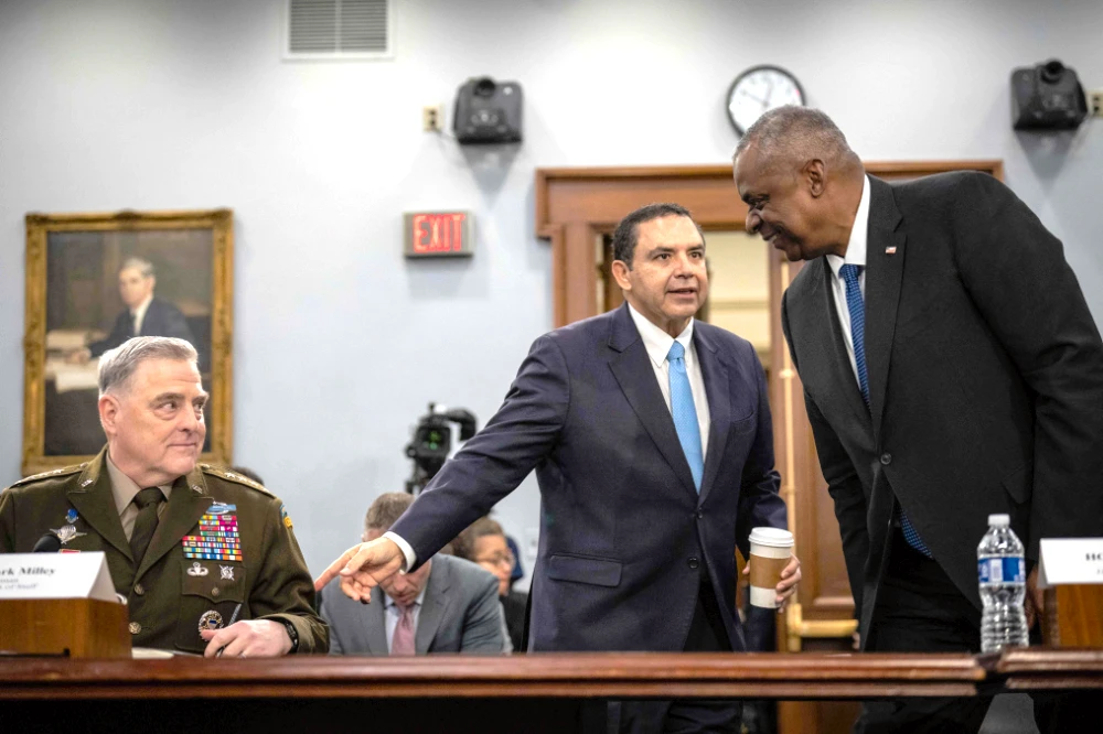 Chairman of the Joint Chiefs of Staff General Mark Milley and U.S. Secretary of Defense Lloyd Austin are greeted by Rep. Henry Cuellar (D-TX) before the start of a House Appropriations Defense Subcommittee hearing on Capitol Hill March 23, 2023 in Washington, DC. (Getty Images/AFP)