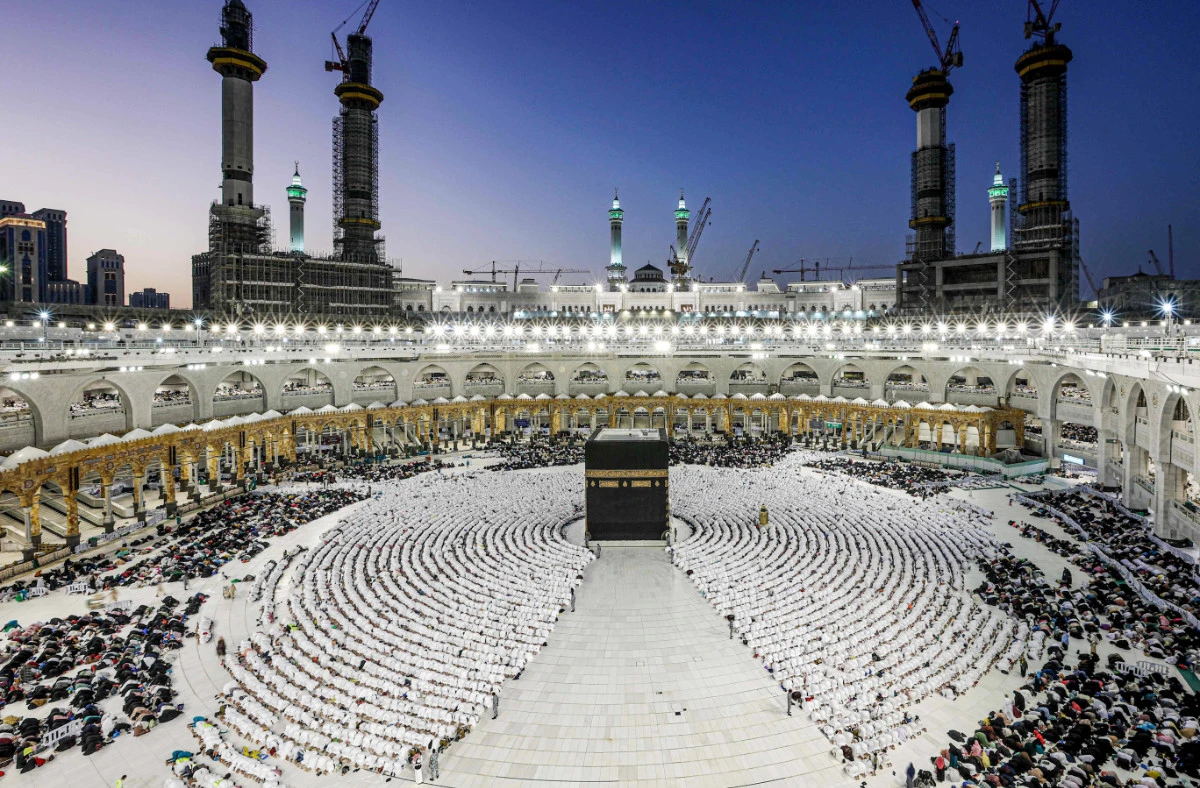 Muslim worshippers gather before the Kaaba, Islam's holiest shrine, as they perform the Maghrib (sunset) prayer to mark the end of the first day of fasting in the holy month of Ramadan, at the Grand Mosque in the holy city of Makkah on March 23, 2023. (AFP)