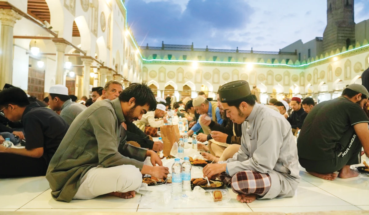 Muslims breaking their fast at a free public iftar in Al-Azhar Mosque in Cairo. (AP)