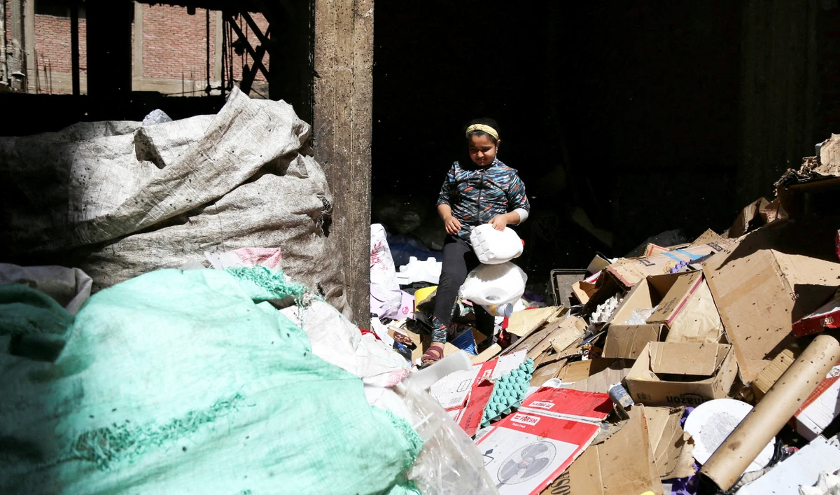 A resident child of Cairo's Zabaleen known as “Garbage City” and member of charity “Mesaha”, collects materials from rubbish to recycle in Manshiyat Nasser, Cairo, Egypt March 17, 2023. (Reuters)
