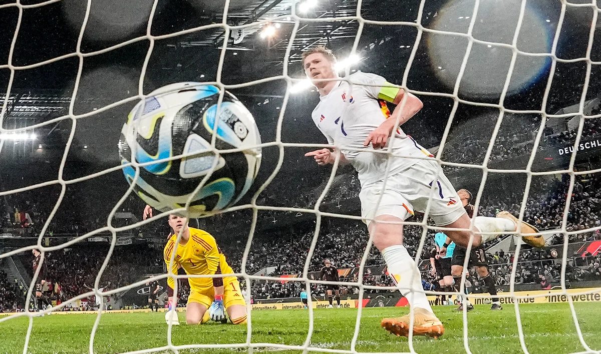 Belgium's Kevin De Bruyne scores his side's third goal against Germany's goalkeeper Marc-Andre her Stegen during the international friendly soccer match between Germany and Belgium in Cologne Tuesday. (AP)