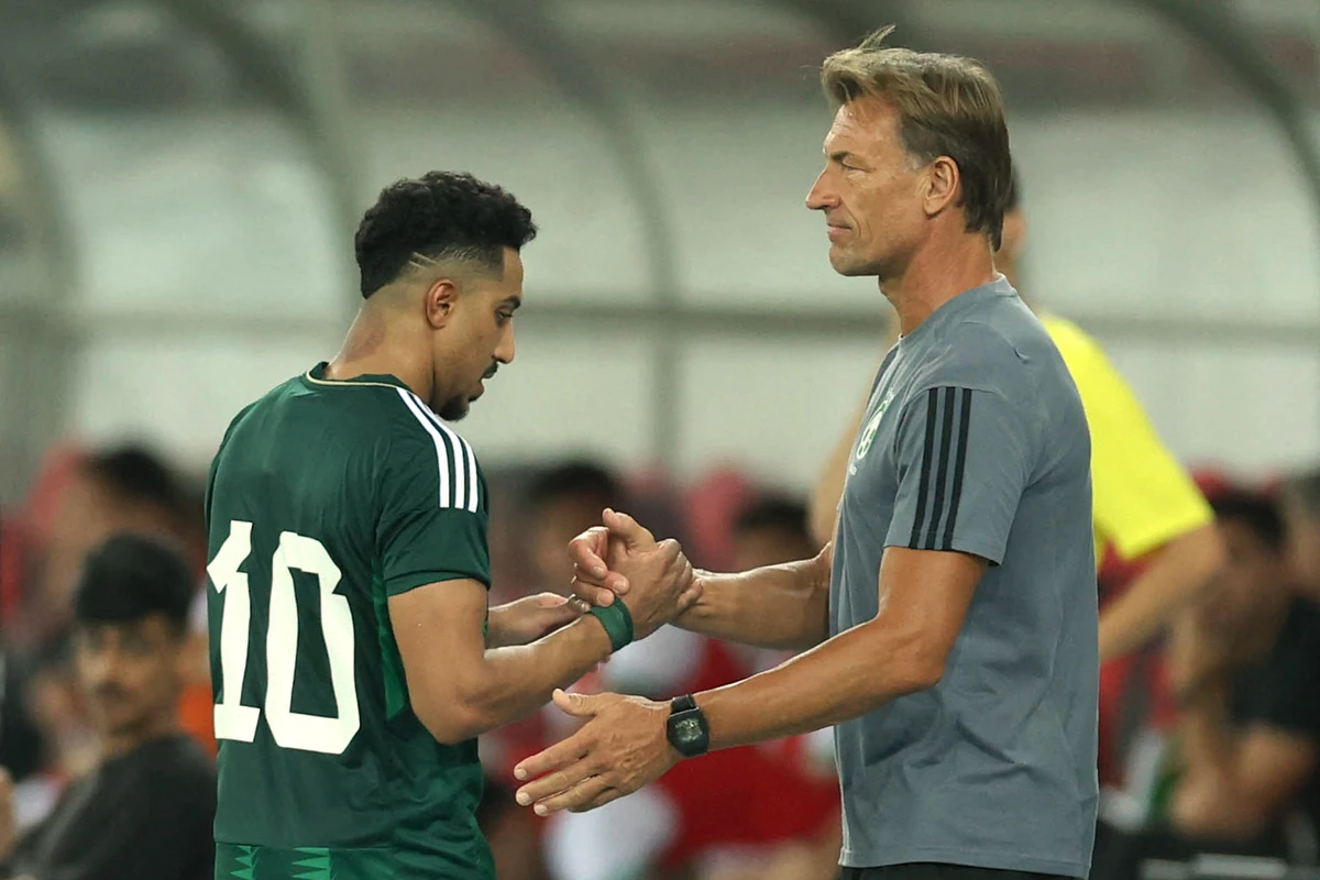 Saudi Arabia's French coach Herve Renard (R) greets Saudi Arabia's midfielder Salem Al-Dawsari during a friendly football match against Bolivia at the Prince Abdullah Al-Faisal Stadium in Jeddah on March 28, 2023. (AFP)