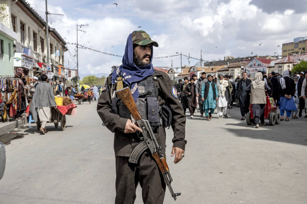 A Taliban fighter stands guard as worshippers attend Friday prayer during the Muslim holy fasting month of Ramadan, in Kabul, Afghanistan, Friday, March 31, 2023. (AP)