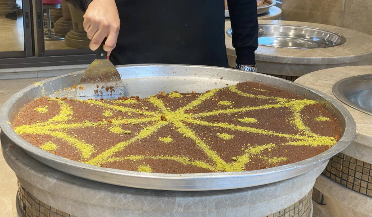 The local version of kunafa in Gaza is brown in color, made with bulgar wheat and semolina, and stuffed with walnuts instead of cheese. (Supplied)