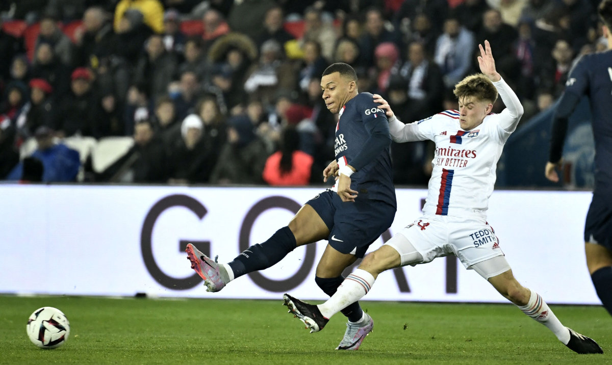 Paris Saint-Germain's French forward Kylian Mbappe and Lyon's French forward Bradley Barcola during their French L1 football match at The Parc des Princes Stadium in Paris on Sunday. (AFP)