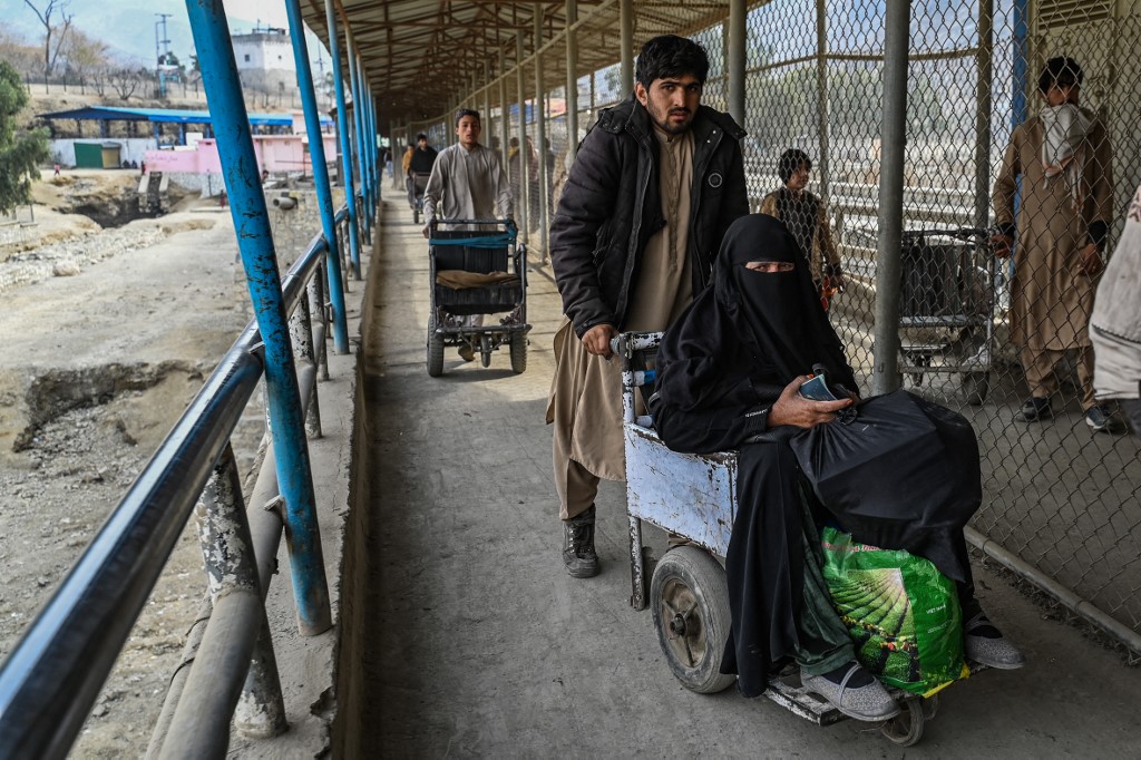 Above, the zero-point Torkham border crossing between Afghanistan and Pakistan in Nangarhar province. Asylum seekers to the UK have been stranded in Pakistan since special Royal Air Force flights have been stopped. (AFP file photo)
