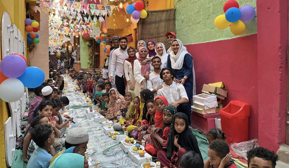 A communal iftar meal is held for street children in the Lyari neighbourhood of Karachi, Pakistan, on March 25, 2023 (Sabina Khatri/Facebook)