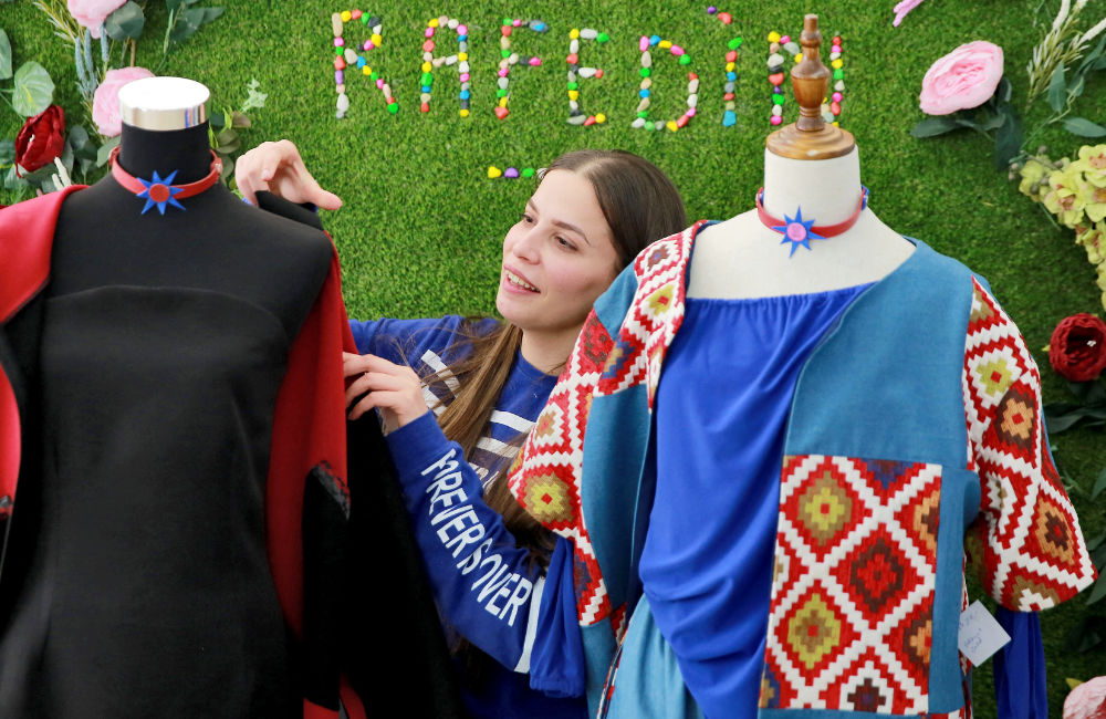 Iraqi woman Sarah Nael inspects creations by ‘Rafedin,’ a sewing project set up by Italians to help Iraqi refugee women in Jordan. Based in the St. Joseph Catholic church in Amman, the project began in 2016 by an Italian priest, along with designers and tailors. (AFP)