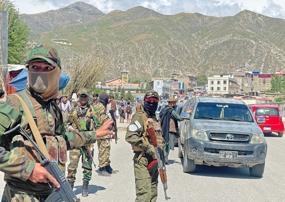 Taliban security personnel stand guard along a street to remove the window tint films from the cars of the commuters at a checkpoint in Fayzabad district of Badakhshan province on April 4, 2023. (AFP)
