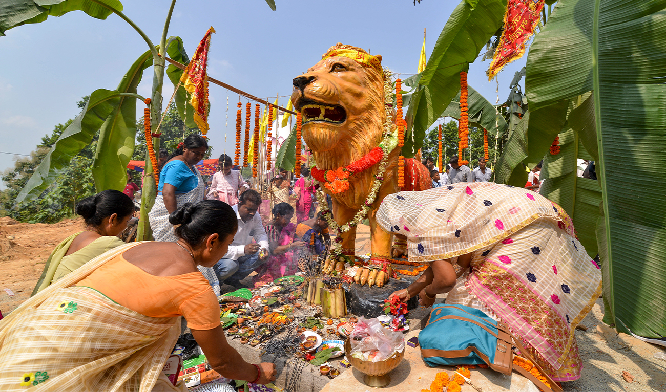 Hindu devotees offer prayers after the buffalos sacrifices at the Buri Goshani Durga temple in Rani village on the outskirts of India's Guwahati on October 6, 2019. (AFP/File)