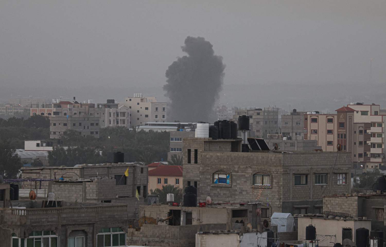 Smoke rises above buildings in Gaza City as Israel launched air strikes on the Palestinian enclave early on April 5, 2023. (AFP)