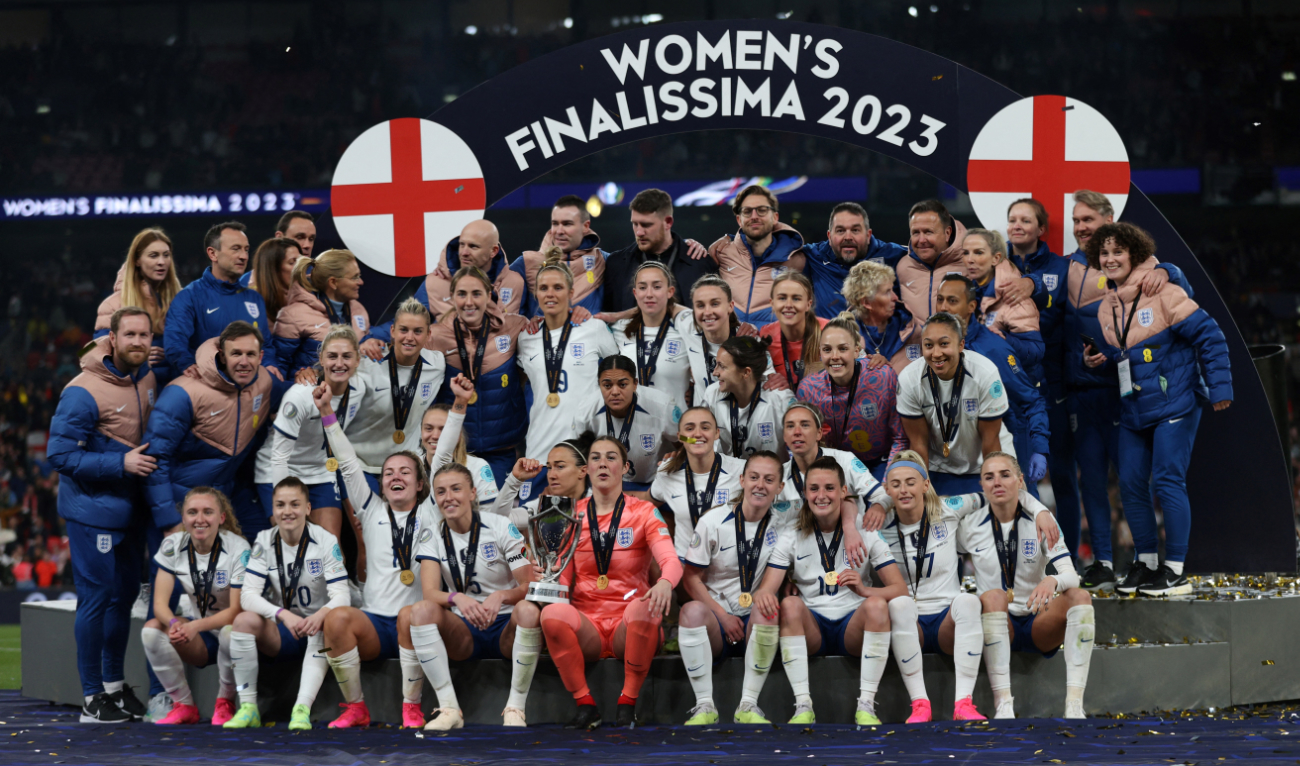 England's players pose with trophy as they celebrate on the pitch after their victory in the Finalissima International football match against Brazil at Wembley Stadium in London on April 6, 2023. (AFP)