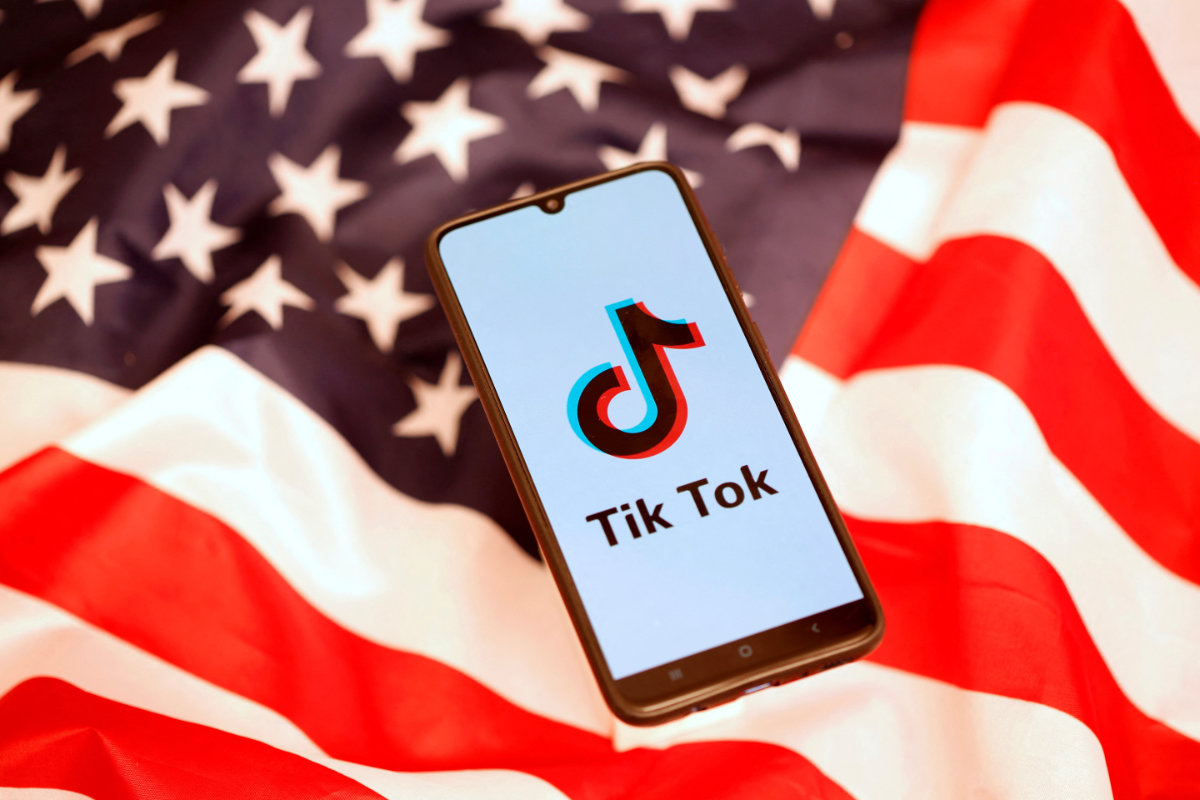 The TikTok logo is displayed on a smartphone a US flag in this illustration picture taken November 8, 2019. (REUTERS/ File Photo)
