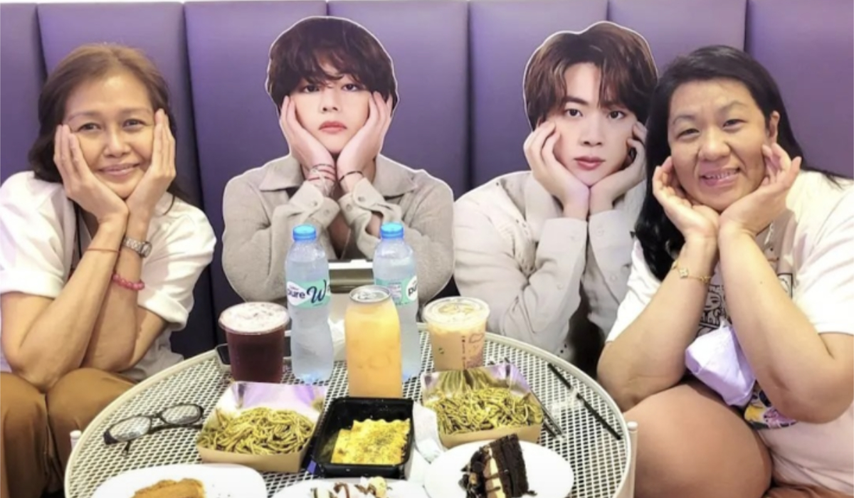 In this undated photo, members of Titas of BTS, a Philippine fanclub of the most famous Korean pop band, pose for a photo with cutouts of two of the boyband's members. (Titas of BTS)