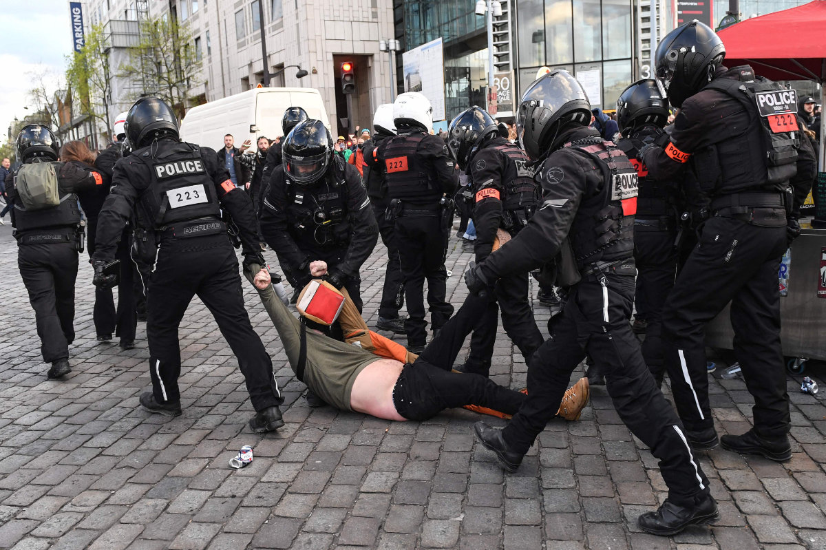 French anti-riot police drag a protester on the ground during a demonstration in Paris against a pensions reform bill on April 6, 2023. (AFP)