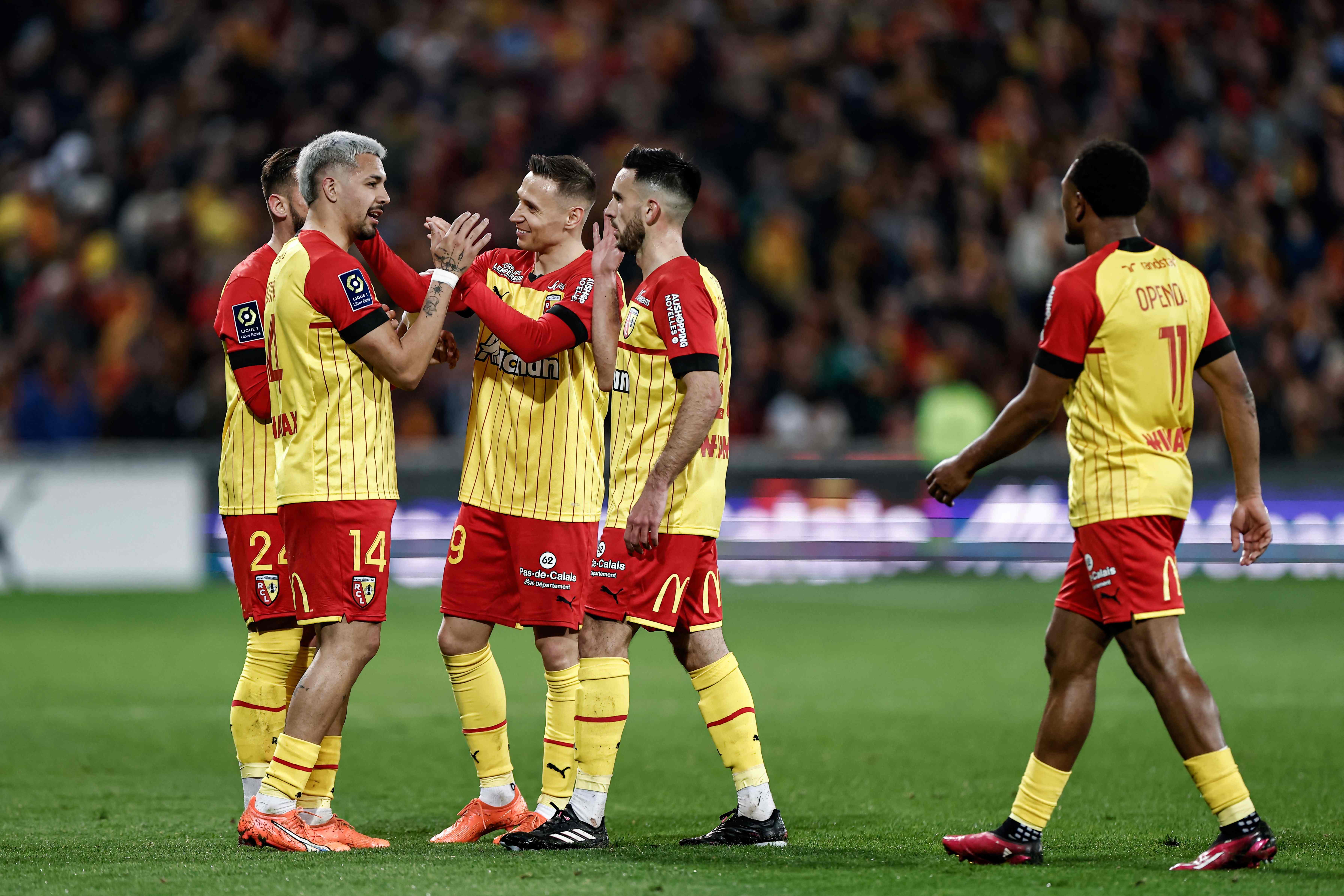 Lens' Argentine defender Facundo Medina (L) celebrates with teammates after scoring a goal during the French L1 football match between RC Lens and RC Strasbourg Alsace at Stade Bollaert-Delelis in Lens, northern France. (AFP)